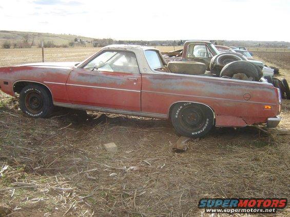 1971 Ford Ranchero side view, red paint faded, tires in bed, another truck behind it