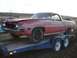 1971 Ford Ranchero - This 1971 Ford Ranchero is being transported on a trailer, showing its distinctive pickup truck bed and car front.