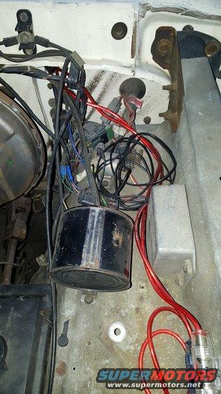 Engine bay wiring harness with black canister and red wires