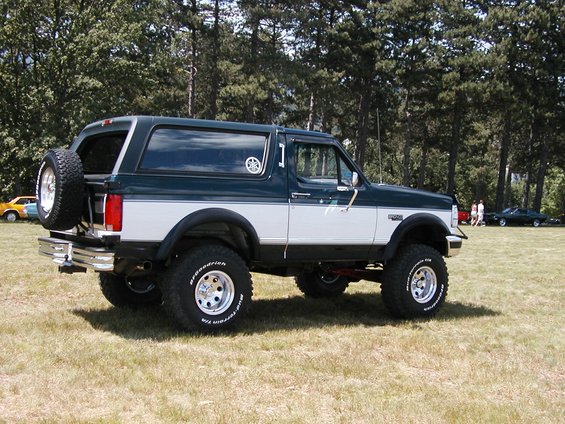 1994 Ford Bronco, dark green and white, with spare tire on rear door