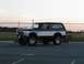 1994 Ford Bronco - Lifted 1994 Ford Bronco parked in a lot during sunset.