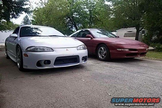 Maroon 1995 Ford Probe parked next to a silver Mitsubishi Eclipse