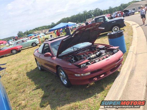 Red coupe with hood open, showing engine. Third-generation Ford Probe body style