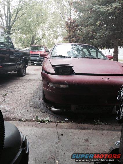 Red 1995 Ford Probe front view with pop-up headlights down