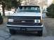 1993 Ford Bronco - This 1993 Ford Bronco is shown from the front, a black bug deflector and a black sun visor.