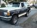 1993 Ford Bronco - This two-tone Ford Bronco is parked on a street with another Bronco visible in the background.