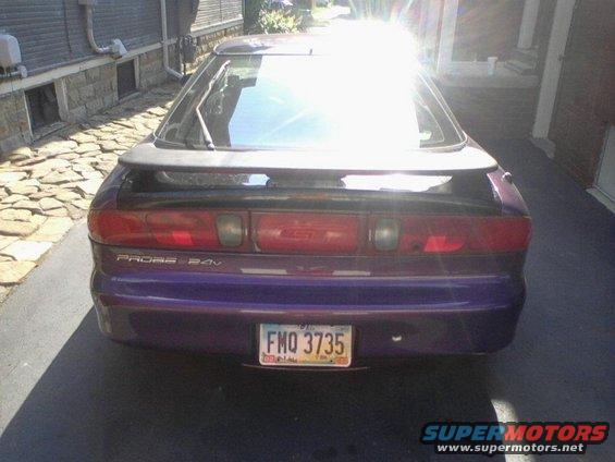 Purple car rear view with spoiler and license plate FMQ 3735