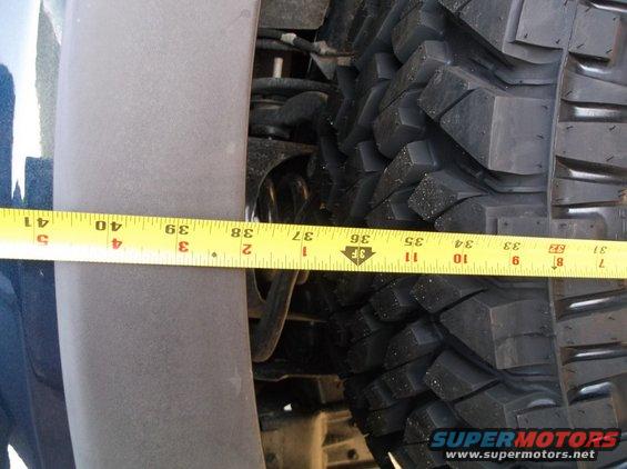 Tape measure across tire tread and fender well
