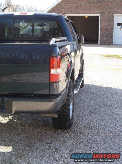 Dark pickup truck rear quarter panel and wheel with Harley-Davidson decal on window