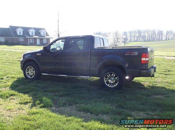 Dark blue Ford F-150 truck with FX4 Off Road badging, parked on grass