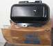 1968 Mercury Cougar - A black metal reservoir part is shown resting on a cardboard box with Ford branding.