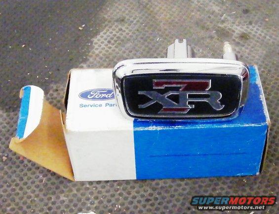 Chrome Ford XR emblem with red lettering on a blue and white Ford Service Parts box