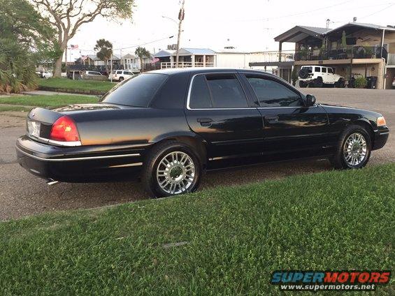 2008 Ford Crown Victoria sedan, side view, parked on grass