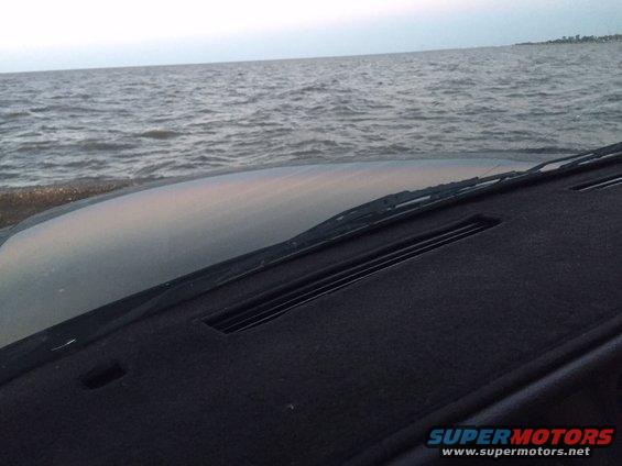 Car dashboard looking out at the ocean