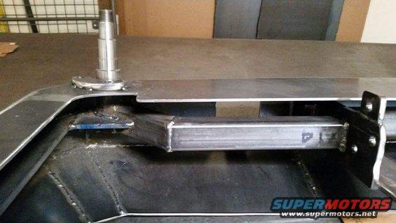 Close-up of a metal frame assembly with a vertical spindle protruding upwards