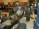 1978 Ford Bronco - Chassis of a 1978 Ford Bronco undergoing work in a garage, engine and transmission are visible.