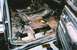 1978 Ford Bronco - The interior of a vehicle shows significant rust damage and is in a state of disassembly.
