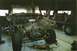 1978 Ford Bronco - A black 1978 Ford Bronco is disassembled and lifted in a garage, with another vehicle visible in the background.