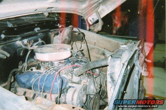 1978 Ford Bronco engine bay with V8 engine, air cleaner, radiator, and alternator visible