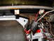 1964 Volkswagen Beetle - The complex wiring under the dashboard of a vehicle shows many exposed wires and connectors.