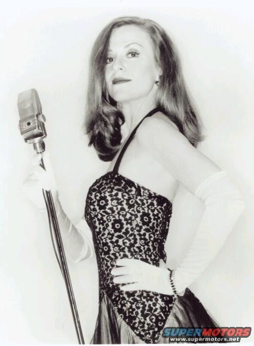 Woman in formal dress holding vintage microphone