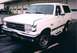 1989 Ford Bronco - White 1989 Ford Bronco with visible damage to the front bumper and headlight area.