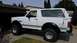 1992 Ford Bronco - This lifted 1992 Ford Bronco is parked in a suburban driveway with a garage in the background.