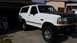 1992 Ford Bronco - This 1992 Ford Bronco is shown from a three-quarter front angle, lifted with off-road tires and a contrasting black hood.