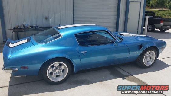 Blue 1970 Pontiac Trans Am with white racing stripes on rear and hood scoop