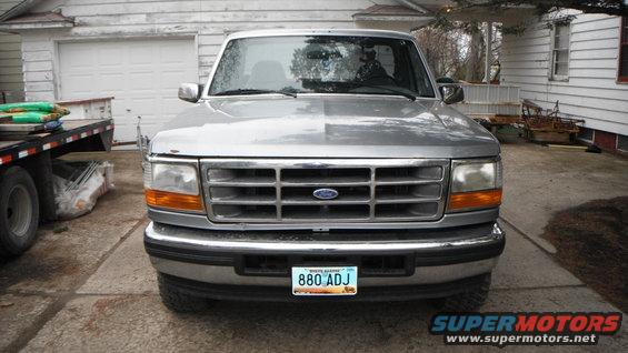 Front view of a silver 1995 Ford F-150 pickup truck parked in a driveway