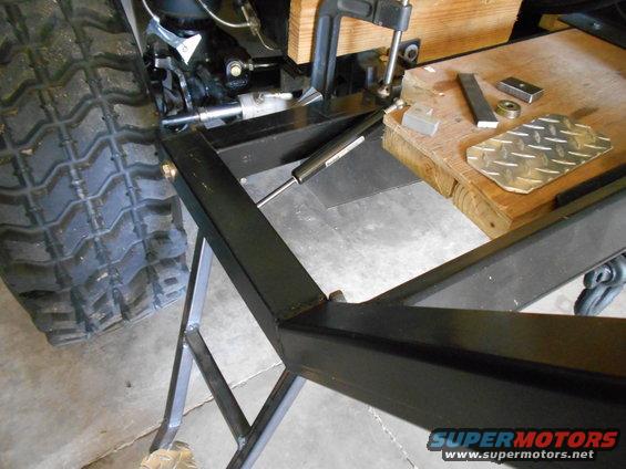 Tire and metal frame with gas strut and clamp
