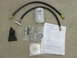 2007 Ford F-250 - A collection of parts for a coolant filter system is laid out on a neutral surface.