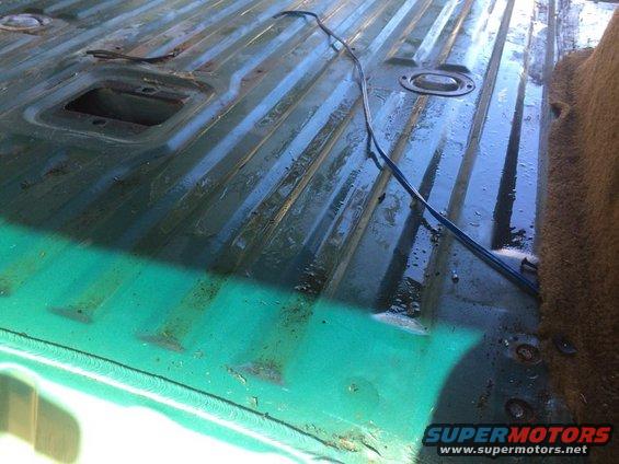 Green interior cargo area with ribbed floor and carpeted side