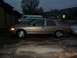 2003 Ford Crown Victoria - Side view of a gold 2003 Ford Crown Victoria parked outside during what appears to be rain.