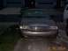 2003 Ford Crown Victoria - The front grille and headlights of a Ford Crown Victoria are visible in this nighttime photo.