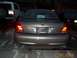 2003 Ford Crown Victoria - A tan sedan is parked in a driveway at night, with a white SUV and another dark vehicle also visible.