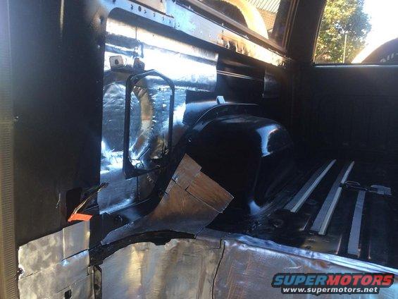 Interior of a vehicle with sound deadening material applied to the floor and rear panels