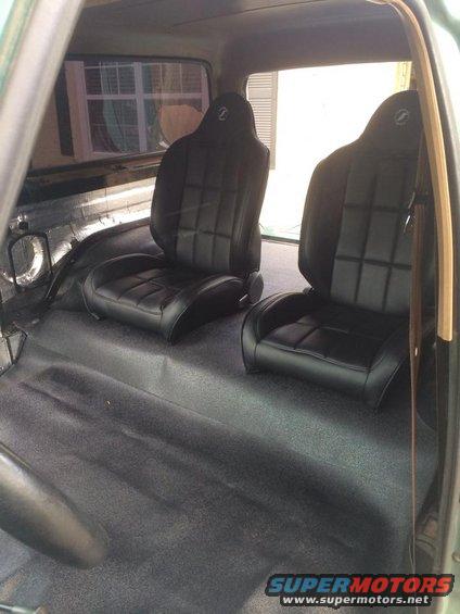 Aftermarket black bucket seats with quilted pattern and 'Z' logo in a vehicle interior
