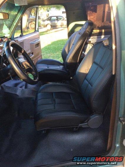 1990 Ford Bronco interior showing black vinyl front seats and dashboard