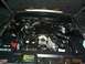 2003 Ford Crown Victoria - The engine bay of a vehicle, showing the V8 engine, various hoses, and the battery. The registry claims it is a 2003 Ford Crown Victoria, b…
