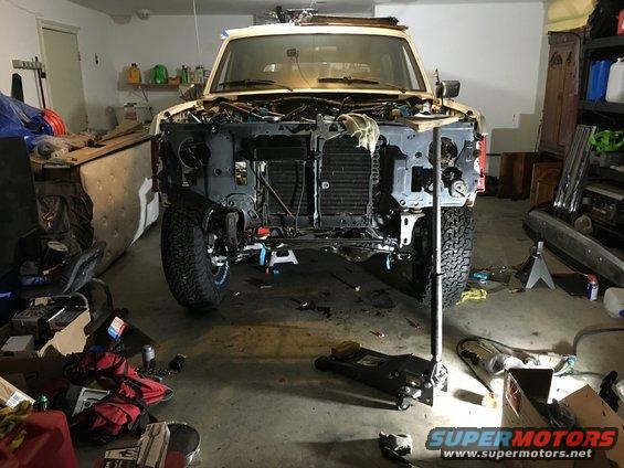 1987 Ford Bronco front end disassembled in garage