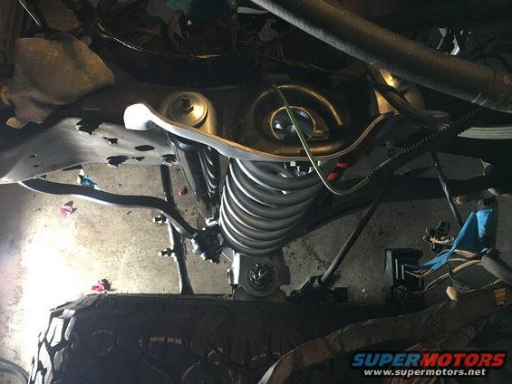 Underside of vehicle with exposed suspension and wiring