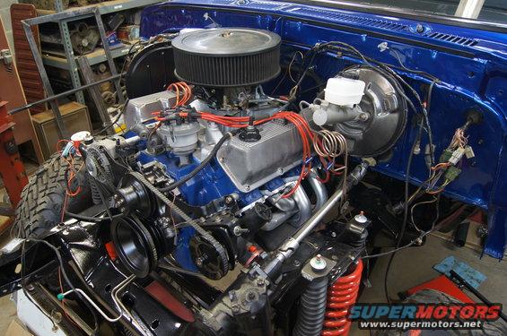 Blue 1979 Ford Bronco engine bay with V8 engine, air filter, and brake booster
