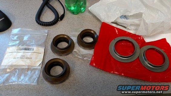 Bagged Bronco front axle seals and loose seals on a red cloth