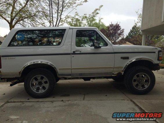 White Ford Bronco SUV, side view, showing 'Gold Edition' badge and aftermarket wheels