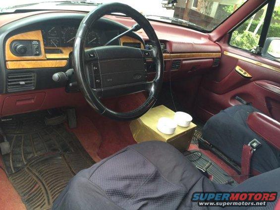 1995 Ford Bronco interior with wood trim and red upholstery