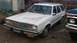 1980 Ford Fairmont - A dusty white 1980 Ford Fairmont station wagon is parked next to another vehicle.