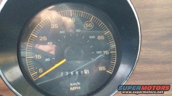 Speedometer gauge with yellow needle, showing 77680 miles and 55 mph