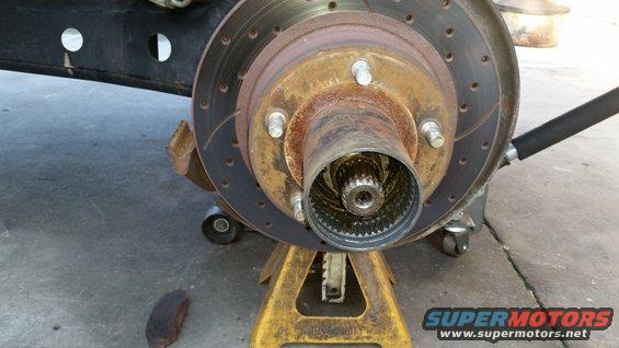 Front wheel hub and brake rotor assembly on jack stands, showing splines inside hub