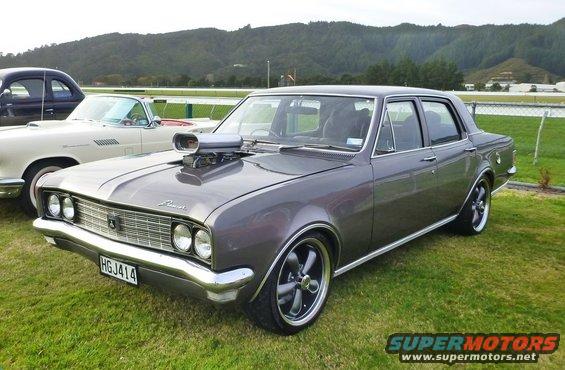 Modified 1969 Holden Brougham sedan with a scoop on the hood and custom wheels. Another car is parked to its left